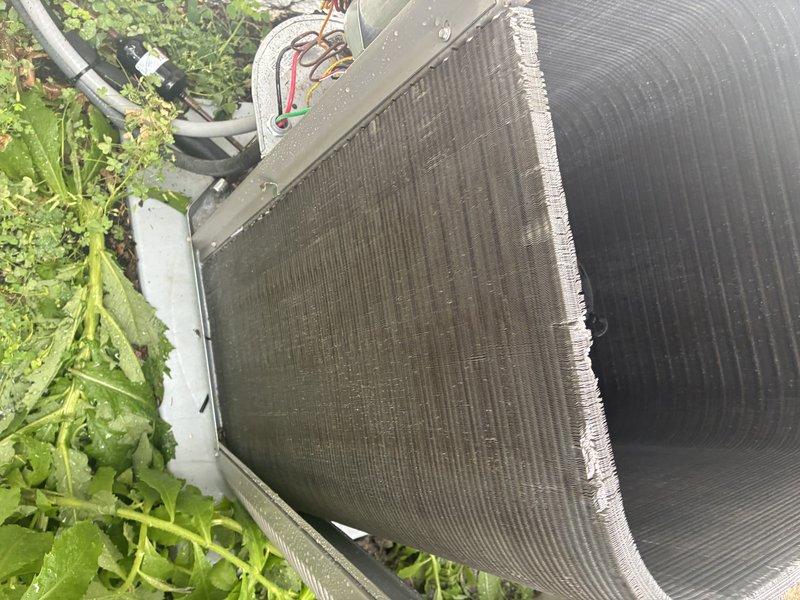 Completed MVP cooling maintenance visit on outdoor condenser unit. Upon inspection, found aluminum fins heavily soiled with dust and debris accumulation affecting airflow efficiency. Performed thorough cleaning of condenser coils and fins to restore optimal heat transfer capacity. Verified electrical connections and wiring integrity at unit. Inspected condensate drainage system and confirmed proper operation of drain line and float assembly. Unit returned to normal operating condition with improved airflow through cleaned coil surfaces.