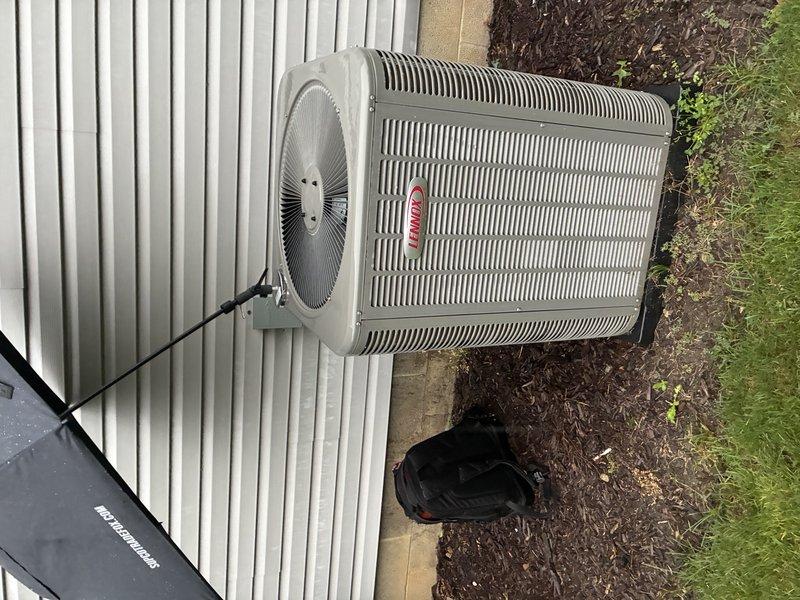 Completed scheduled MVP cooling maintenance visit on 2-year-old residential HVAC system. Performed comprehensive inspection of outdoor condenser unit and indoor air distribution components, including examination of heat exchanger coils, supply diffuser, and overall system operation. Documented equipment condition through photographic records showing proper installation on concrete pad with adequate clearance and functioning air delivery system with clean metallic diffuser blades directing airflow appropriately.