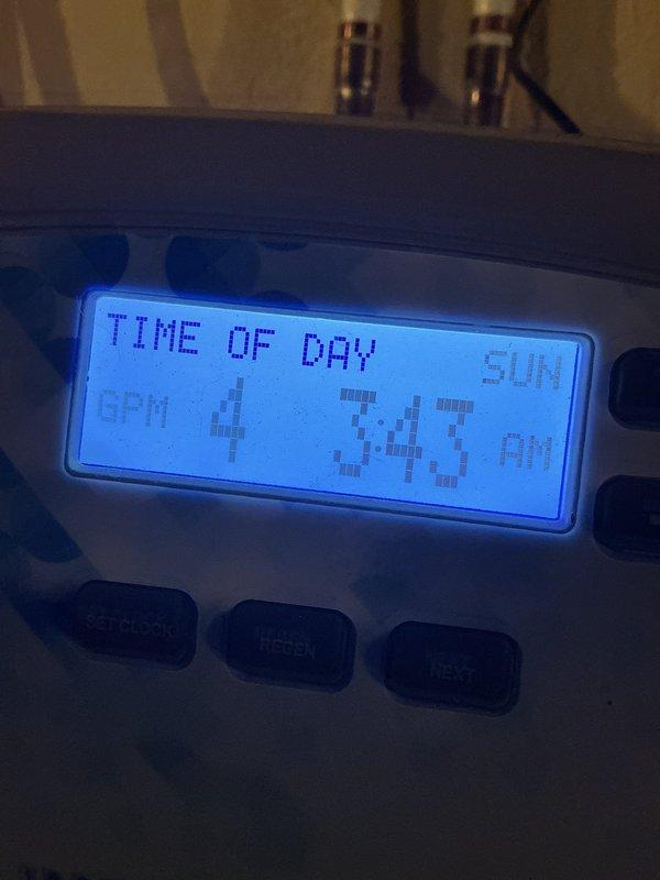 Performed scheduled maintenance on water softener system. Verified control unit operation, confirmed system displaying 896 total days of service with proper time settings at 3:43 AM regeneration cycle. All system functions tested and operating within normal parameters.