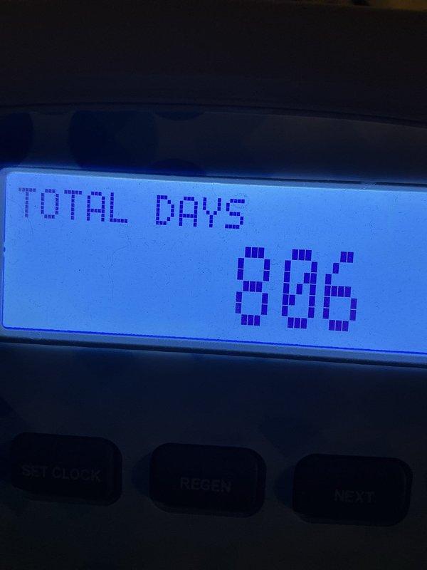 Performed scheduled maintenance on water softener system. Verified control unit operation, confirmed system displaying 896 total days of service with proper time settings at 3:43 AM regeneration cycle. All system functions tested and operating within normal parameters.
