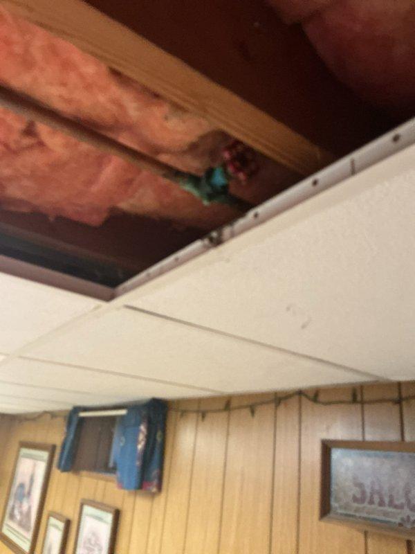 Responded to a basement water leak investigation and repair. Removed drop ceiling sections to access plumbing system and identified a failed gate valve as the primary source of active dripping. Due to limited visibility in the ceiling cavity, coordinated with restoration services to assess water damage extent and confirm no additional leak sources. Replaced the leaking gate valve with a new ball valve to immediately stop water intrusion. Additionally replaced a second heavily corroded ball valve in the same area as preventive maintenance to avoid future failure. Completed all valve replacements during service visit to eliminate active leak and mitigate potential water damage risk from deteriorating components.