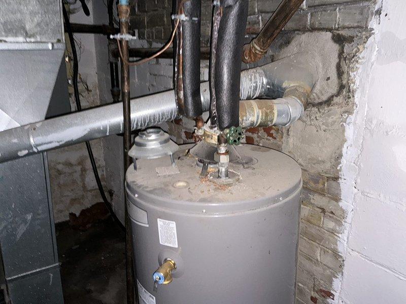 Conducted comprehensive assessment of existing HVAC system in basement mechanical room for complete furnace and air conditioning replacement estimate. Evaluated current Luxaire furnace unit and associated air handler, documented existing ductwork configuration including flexible and rigid metal ducts, and assessed utility room infrastructure including water heater clearances and available space for new equipment installation. Photographed all existing equipment, connections, and mechanical room layout to provide accurate replacement specifications for bundled furnace and AC system upgrade per promotional offer inquiry.