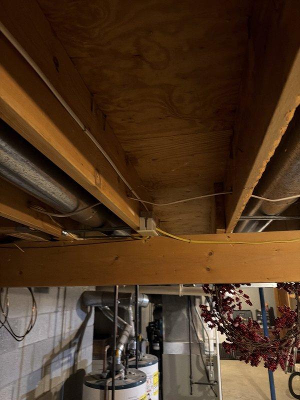 Installed three new electrical outlets in unfinished basement area using surface-mounted conduit and outlet boxes on concrete block walls. Ran black EMT conduit vertically along painted CMU wall with proper mounting straps, installed standard duplex receptacles and GFCI protection where required per code. All materials were available from truck stock, and installation was completed through exposed floor joist space with appropriate wire routing and support.