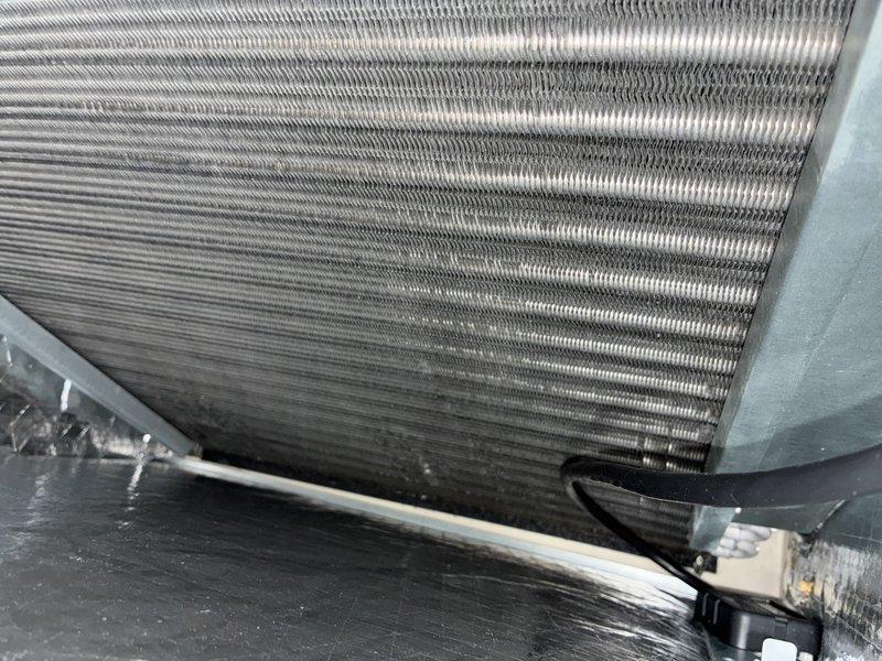 Completed annual maintenance on 1-year-old air conditioning system. Inspected evaporator coil and found minor dust accumulation on fins; coil remains in good operational condition with normal condensate drainage present. Replaced air filter per customer request and verified all system components are functioning properly for continued efficient cooling operation.