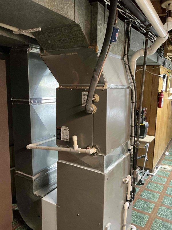 Conducted estimate for replacement of 14-year-old residential HVAC system with confirmed refrigerant leak. Assessed existing gray metal furnace unit with associated ductwork, PVC condensate lines, and electrical connections in basement mechanical room. Provided comprehensive quote for complete system replacement due to age and leak repair costs exceeding viability threshold.