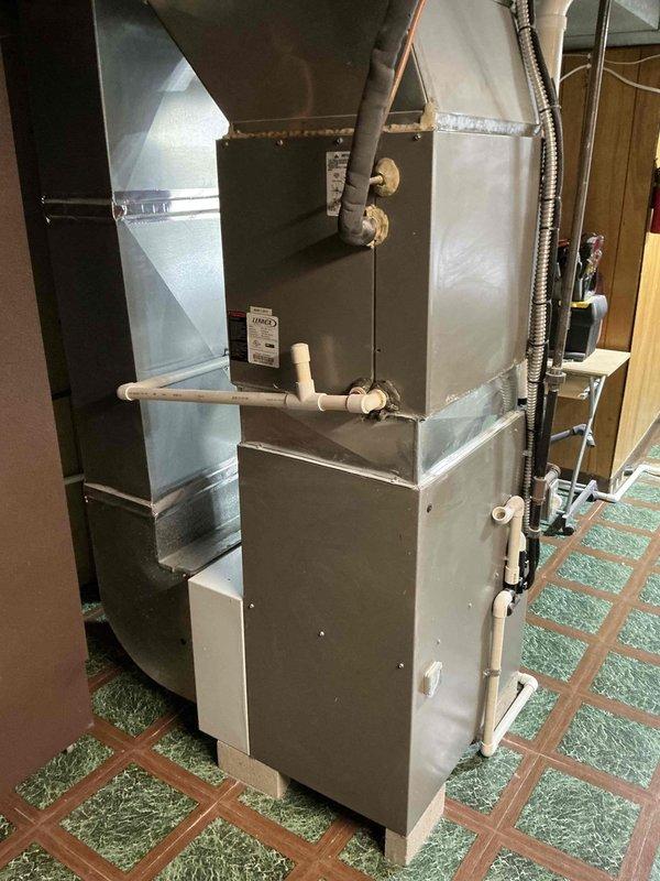 Conducted estimate for replacement of 14-year-old residential HVAC system with confirmed refrigerant leak. Assessed existing gray metal furnace unit with associated ductwork, PVC condensate lines, and electrical connections in basement mechanical room. Provided comprehensive quote for complete system replacement due to age and leak repair costs exceeding viability threshold.