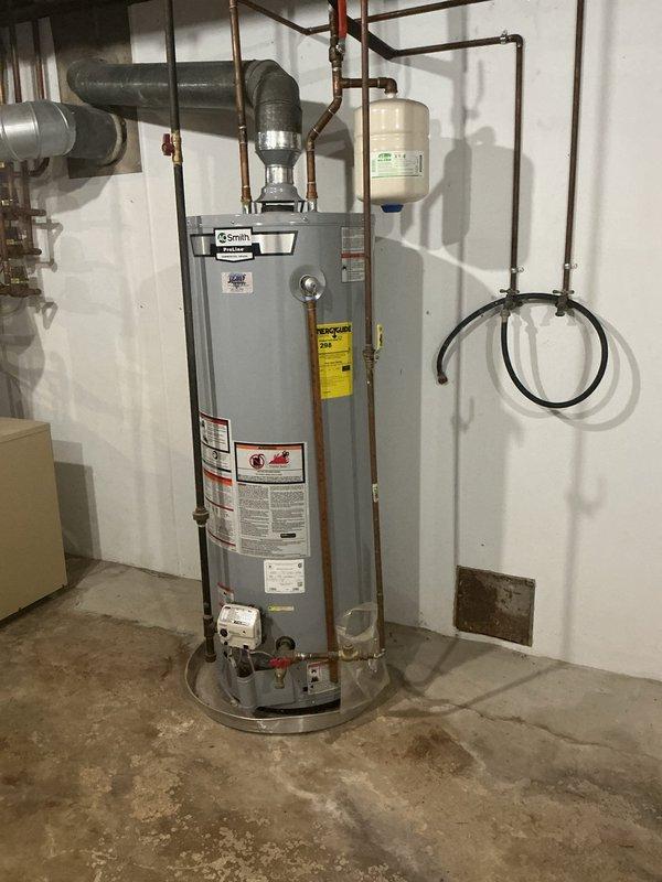 Responded to service call for A.O. Smith ProLine tanked water heater not producing adequate hot water. Upon arrival, performed diagnostic inspection of unit and associated plumbing components. Evaluated water heater operation, checked temperature settings, and inspected copper supply lines, expansion tank, shut-off valves, and gas line connections. Documented existing installation configuration including properly mounted expansion tank, isolation valves, and pressure relief components. System assessment completed and findings documented with photographic evidence of unit condition and plumbing infrastructure in basement utility room.