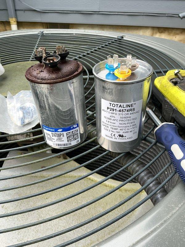 # HVAC Service Completed

Responded to service call for 11-year-old residential air conditioning system experiencing excessive noise and reduced efficiency. Upon arrival, performed visual inspection of outdoor condensing units located on building exterior.

Identified failed dual-run capacitor on affected unit showing severe corrosion and oxidation on terminal connections. The deteriorated capacitor was causing motor strain, resulting in abnormal operating sounds and decreased system performance. Removed defective capacitor and installed new Totaline replacement capacitor (P291-4574RS) with proper MFD ratings and voltage specifications matching unit requirements. Verified secure wire connections to compressor and fan motor terminals. Tested system operation and confirmed normal sound levels and proper cooling cycle. Unit now operating within manufacturer specifications with restored efficiency.