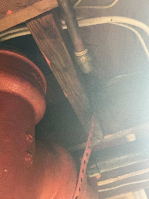 Responded to a possible warranty recall for water leakage near the sand pipe that connects to the sewer system. Investigated the leak location in the utility area near the water heater and plumbing infrastructure to determine if the issue was related to a previous repair completed earlier in the month. Documented the condition of the copper piping, connections, and surrounding plumbing components with photographs for warranty evaluation and future reference.