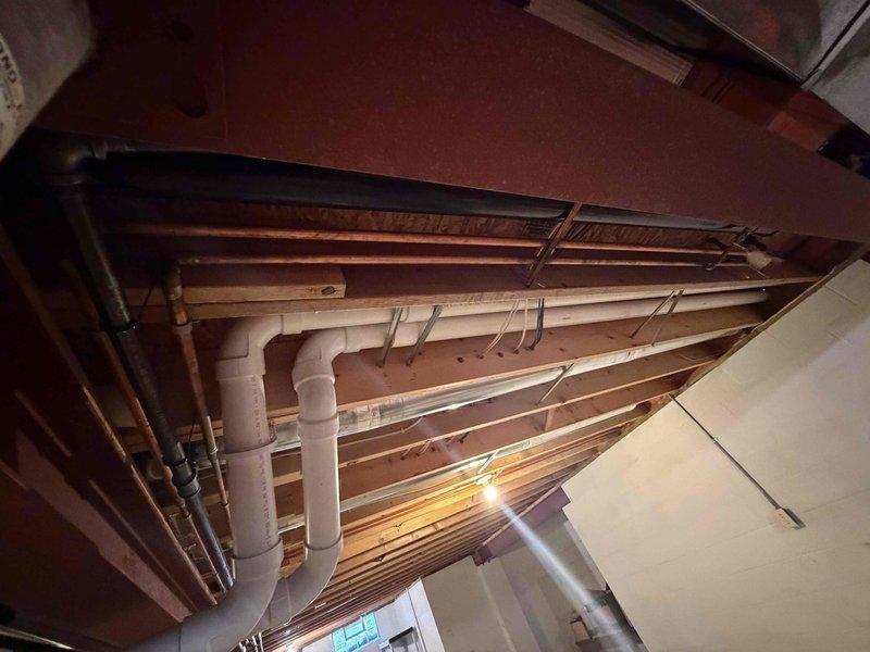 Completed installation of a 90% efficiency furnace and air conditioning system. Installed new FLNR 40-amp dual fuses in exterior disconnect for AC unit protection. Routed necessary refrigerant lines, electrical connections, and condensate drainage through existing basement ceiling joists alongside current plumbing infrastructure to connect outdoor condensing unit to indoor air handler.