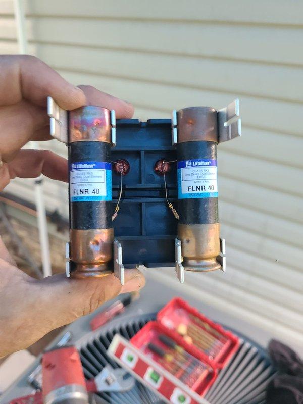 Completed installation of a 90% efficiency furnace and air conditioning system. Installed new FLNR 40-amp dual fuses in exterior disconnect for AC unit protection. Routed necessary refrigerant lines, electrical connections, and condensate drainage through existing basement ceiling joists alongside current plumbing infrastructure to connect outdoor condensing unit to indoor air handler.