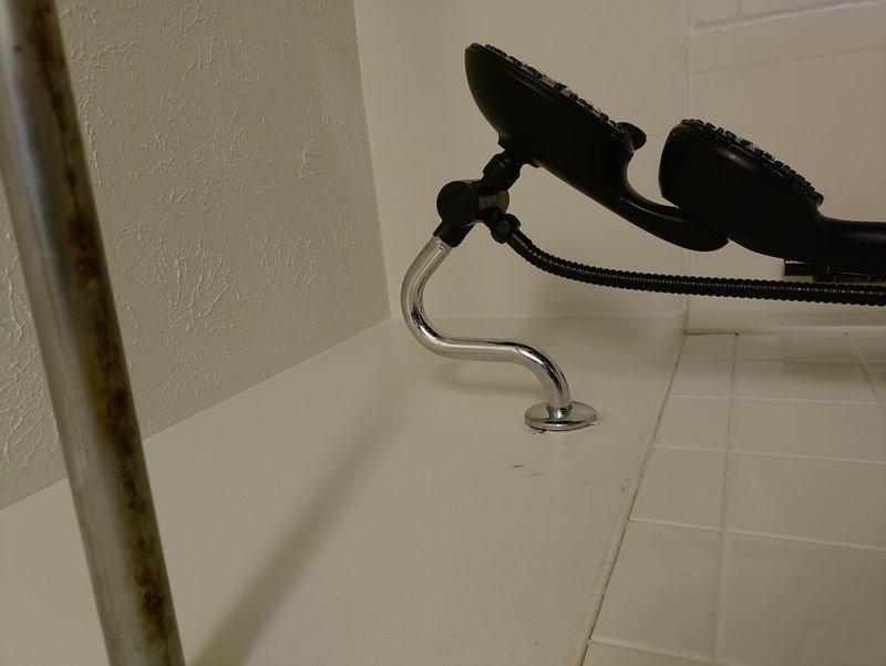 Replaced outdated stem-style bathtub faucet with new single-handle Moen shower valve system. Accessed plumbing from rear wall cavity to remove old fixtures and install new valve assembly with chrome trim and remodel plate to cover previous mounting holes. All parts staged and installation completed with new hardware in place.