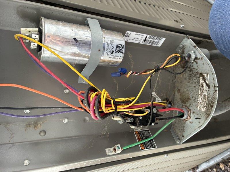 Completed MVP cooling maintenance visit on residential HVAC system. Inspected outdoor condenser unit and indoor air handler components, documenting heavily soiled air filter with significant accumulation of dust and debris requiring replacement. Examined capacitor, blower motor assembly, and electrical connections; noted rust staining on motor housing consistent with normal environmental exposure over time. All system components operational and electrical connections secure.