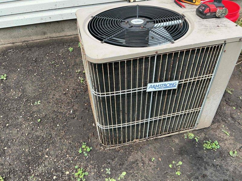 Responded to no cooling complaint on 8-year-old Armstrong air conditioning system. Upon inspection, found condenser coil heavily contaminated with dirt, dust, and debris accumulation restricting airflow. Cleaned condenser coil thoroughly to restore proper heat transfer and system efficiency. Unit now operating with adequate cooling capacity.