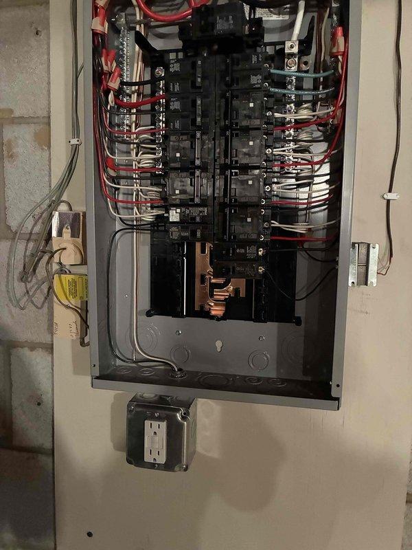 Completed 100-amp electrical panel replacement with full code compliance upgrades per 2023 National Electrical Code requirements, including installation of exterior disconnect. Added GFCI protection to multiple circuits throughout the residence: kitchen countertop receptacles, family room wet bar, refrigerator, dishwasher, garbage disposal, furnace outlet, and washing machine circuits. Relocated and properly crimped existing water line ground connection to exterior disconnect. All wiring organized and terminated according to current electrical standards with proper circuit identification and breaker configuration.
