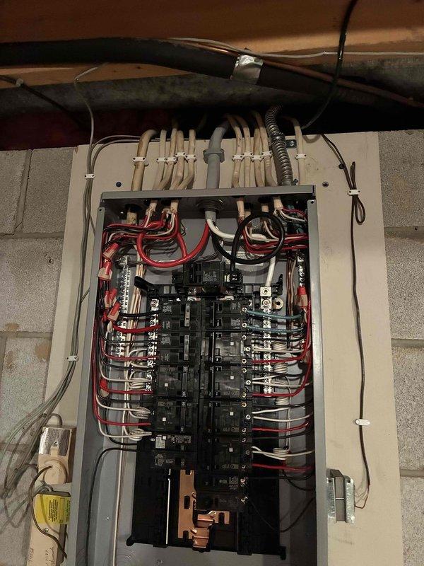 Completed 100-amp electrical panel replacement with full code compliance upgrades per 2023 National Electrical Code requirements, including installation of exterior disconnect. Added GFCI protection to multiple circuits throughout the residence: kitchen countertop receptacles, family room wet bar, refrigerator, dishwasher, garbage disposal, furnace outlet, and washing machine circuits. Relocated and properly crimped existing water line ground connection to exterior disconnect. All wiring organized and terminated according to current electrical standards with proper circuit identification and breaker configuration.
