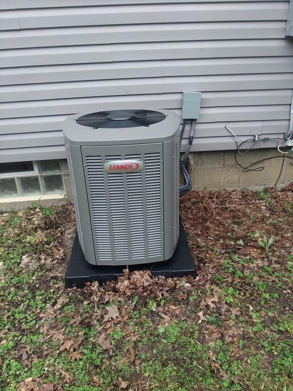 Completed installation of Lennox air conditioning condenser unit and evaporator coil at residential property. Unit was positioned on pad at exterior location with proper electrical disconnect box mounted adjacent to condenser, including installation of FLNR 20A fuses in disconnect assembly. All refrigerant lines, electrical connections, and condensate drainage were properly installed and secured per manufacturer specifications, with system tested and verified operational upon completion.