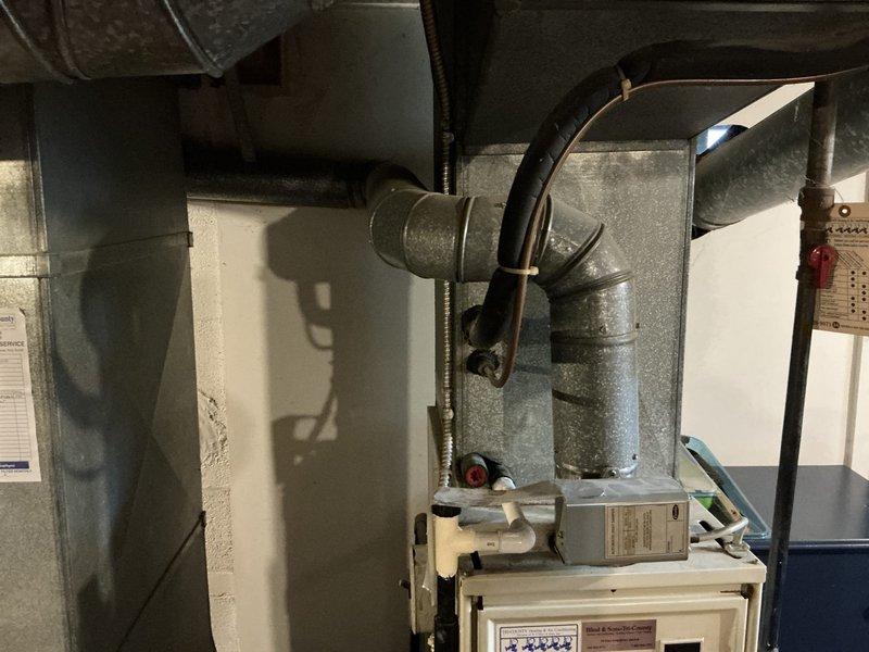 Evaluated 37-year-old R22 system found low on refrigerant. Due to system age, obsolete refrigerant type, and repair costs exceeding replacement value, provided comprehensive estimate for complete furnace and air conditioning system replacement. Documented existing equipment configuration including furnace, ductwork, and associated HVAC components in basement mechanical room for replacement specifications.