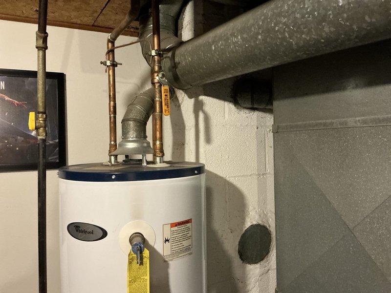Evaluated 37-year-old R22 system found low on refrigerant. Due to system age, obsolete refrigerant type, and repair costs exceeding replacement value, provided comprehensive estimate for complete furnace and air conditioning system replacement. Documented existing equipment configuration including furnace, ductwork, and associated HVAC components in basement mechanical room for replacement specifications.