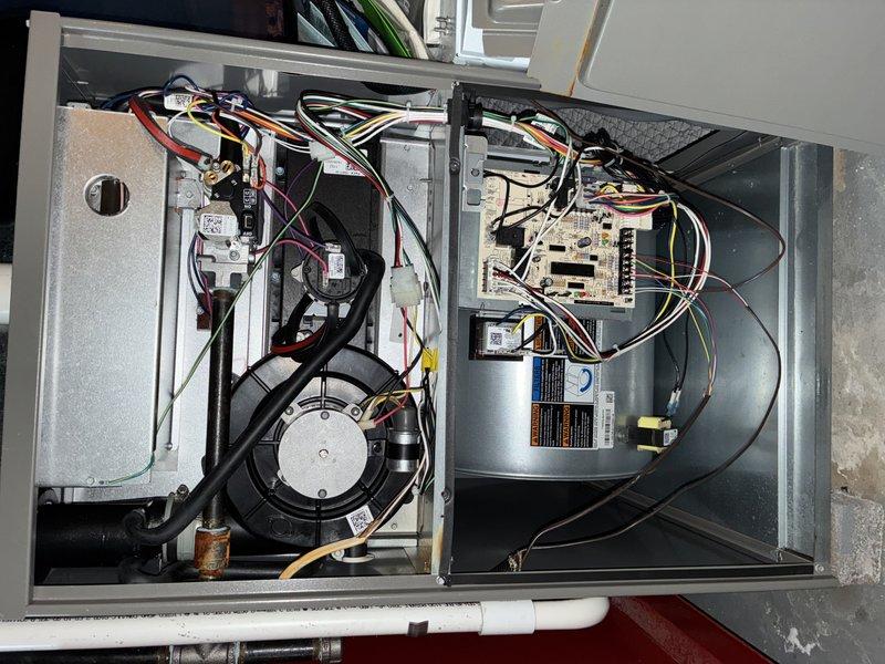 Completed MVP cooling maintenance visit on 14-year-old HVAC system. Performed comprehensive inspection of both indoor furnace unit and outdoor condensing unit. Indoor unit inspection revealed operational blower motor, heat exchanger assembly, and control board with proper wire connections and functional transformer components. Outdoor unit contained significant debris accumulation including leaves, twigs, mulch, and vegetation growth within the electrical compartment. Inspected capacitor, refrigerant lines, and electrical connections throughout both units. All components photographed and documented for maintenance records.