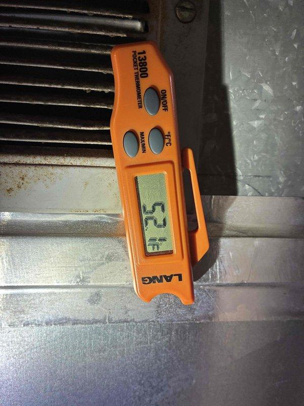 Completed preventive maintenance on 12-year-old York air conditioning system with outdoor condensing unit and basement air handler. Performed comprehensive inspection of both indoor and outdoor components, verified system operation with supply air temperature reading of 52°F, cleaned condenser coils, checked refrigerant levels, and confirmed proper airflow through heat exchanger. All components operating within normal parameters and unit functioning efficiently.