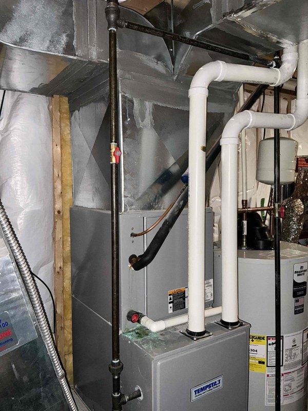 Performed comprehensive evaluation of existing Tempstar HVAC system. Identified multiple critical issues including heavily corroded evaporator coil with condensation leaking from coil box onto furnace, suspected inducer trap leak, and abnormal refrigerant levels indicating indoor airflow or TXV malfunction. Condenser fan exhibited rust indicating overheating conditions. Capacitor measured below tolerance on compressor side, creating risk of compressor damage. Contactor displayed pitted connections and loud electrical hum signaling component failure. Blower wheel showed heavy dust accumulation and microbial growth. System currently cooling but operating inefficiently with multiple components at or near end of service life. Documented equipment condition with photographs showing installation configuration, existing ductwork, venting components, and overall system layout. Recommended complete system replacement due to extent of deterioration and cascading failure risks that would make ind