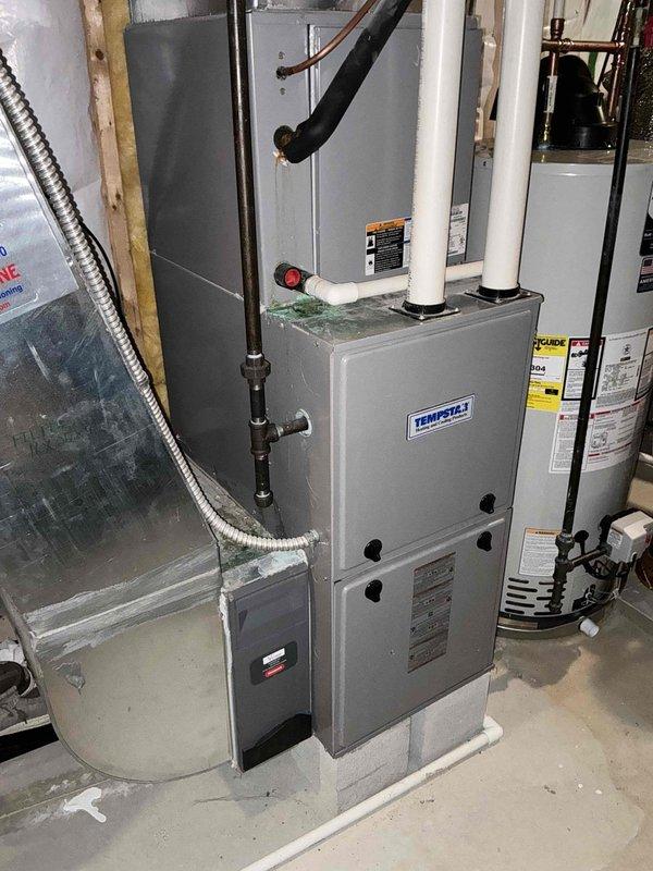 Performed comprehensive evaluation of existing Tempstar HVAC system. Identified multiple critical issues including heavily corroded evaporator coil with condensation leaking from coil box onto furnace, suspected inducer trap leak, and abnormal refrigerant levels indicating indoor airflow or TXV malfunction. Condenser fan exhibited rust indicating overheating conditions. Capacitor measured below tolerance on compressor side, creating risk of compressor damage. Contactor displayed pitted connections and loud electrical hum signaling component failure. Blower wheel showed heavy dust accumulation and microbial growth. System currently cooling but operating inefficiently with multiple components at or near end of service life. Documented equipment condition with photographs showing installation configuration, existing ductwork, venting components, and overall system layout. Recommended complete system replacement due to extent of deterioration and cascading failure risks that would make ind
