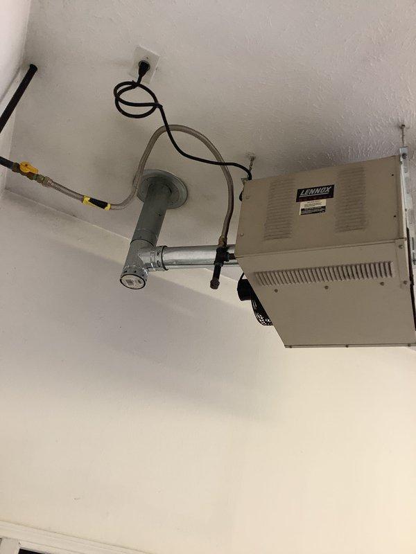Conducted estimate for garage heater replacement. Assessed existing Lennox ceiling-mounted unit with associated ductwork, electrical connections, and attic infrastructure. Documented current system configuration including flexible ductwork routing through attic space, electrical wiring installation, and copper refrigerant lines with insulation. Photographed equipment location, mounting arrangement, and surrounding structural conditions to provide comprehensive replacement specifications.