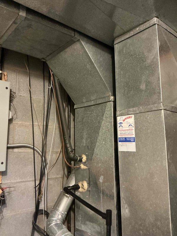 Conducted on-site assessment of existing air conditioning system for replacement estimate. Evaluated outdoor condenser unit located at grade level adjacent to deck structure, noting older equipment with operational issues requiring full system replacement. Inspected indoor components including ductwork distribution system in mechanical room with sheet metal trunk lines and branch connections to existing electrical service panel. Documented current equipment configuration, electrical connections, and ductwork layout to provide comprehensive replacement specifications for new HVAC system installation.