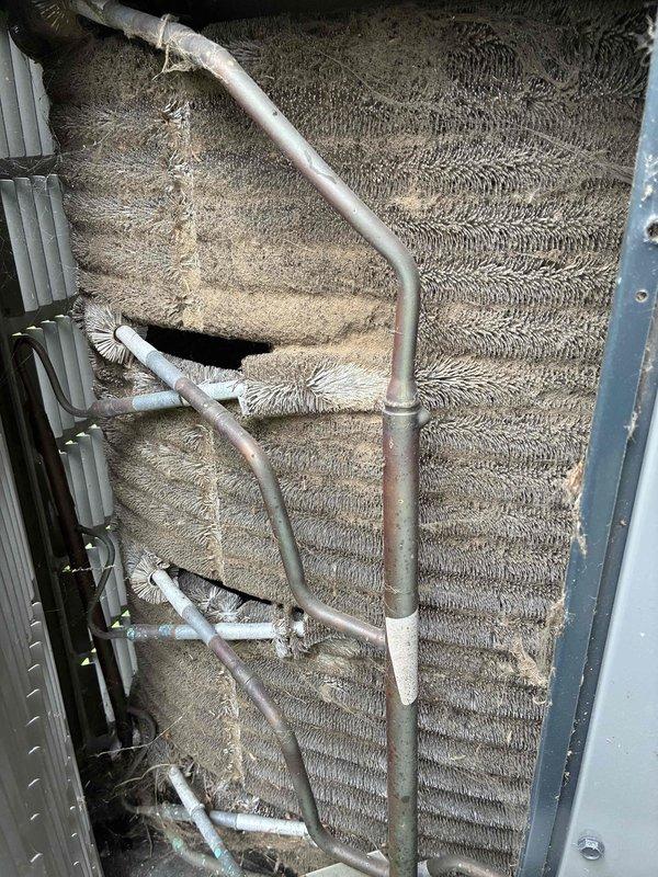 # HVAC Maintenance - Cooling

Completed routine preventive maintenance on an 8-year-old air conditioning system. Performed comprehensive inspection of evaporator coil assembly, noting dust and debris accumulation on aluminum fins. Examined refrigerant lines, including copper piping with insulation sleeves showing age-related wear and discoloration. Verified proper installation of line securing clips and brackets. Inspected internal components including drain pan, condensate drainage system with white PVC piping, and metal housing panels. All copper tubing displayed normal oxidation patterns consistent with system age. System operational and functioning within normal parameters upon completion of maintenance visit.