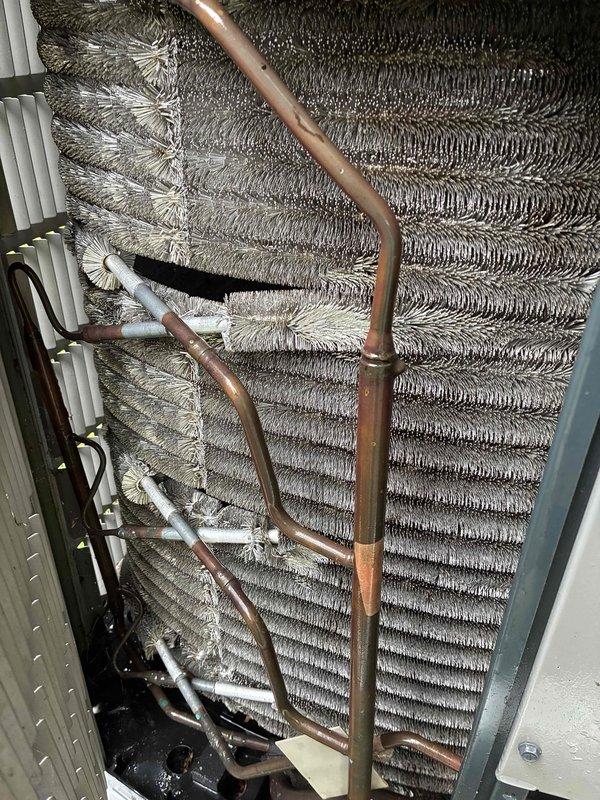 # HVAC Maintenance - Cooling

Completed routine preventive maintenance on an 8-year-old air conditioning system. Performed comprehensive inspection of evaporator coil assembly, noting dust and debris accumulation on aluminum fins. Examined refrigerant lines, including copper piping with insulation sleeves showing age-related wear and discoloration. Verified proper installation of line securing clips and brackets. Inspected internal components including drain pan, condensate drainage system with white PVC piping, and metal housing panels. All copper tubing displayed normal oxidation patterns consistent with system age. System operational and functioning within normal parameters upon completion of maintenance visit.