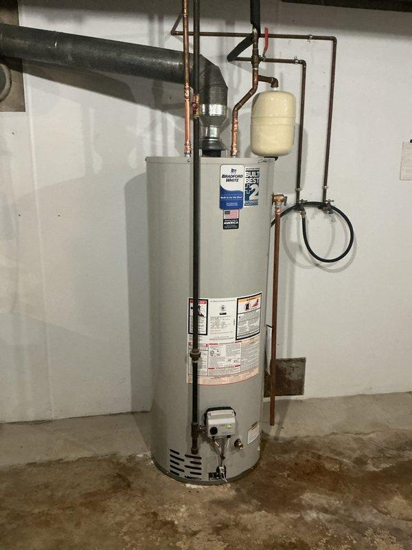 Replaced a failed 2018 A.O. Smith 50-gallon gas water heater with a new Bradford White 50-gallon gas unit featuring an 8-year manufacturer warranty. Installed a new thermal expansion tank to replace the existing unit and properly disconnected and capped the recirculating line approximately 12 inches below the ball valve. All copper supply lines were connected to the new water heater, and the gas line and flue vent were properly configured to ensure safe operation of the new system.