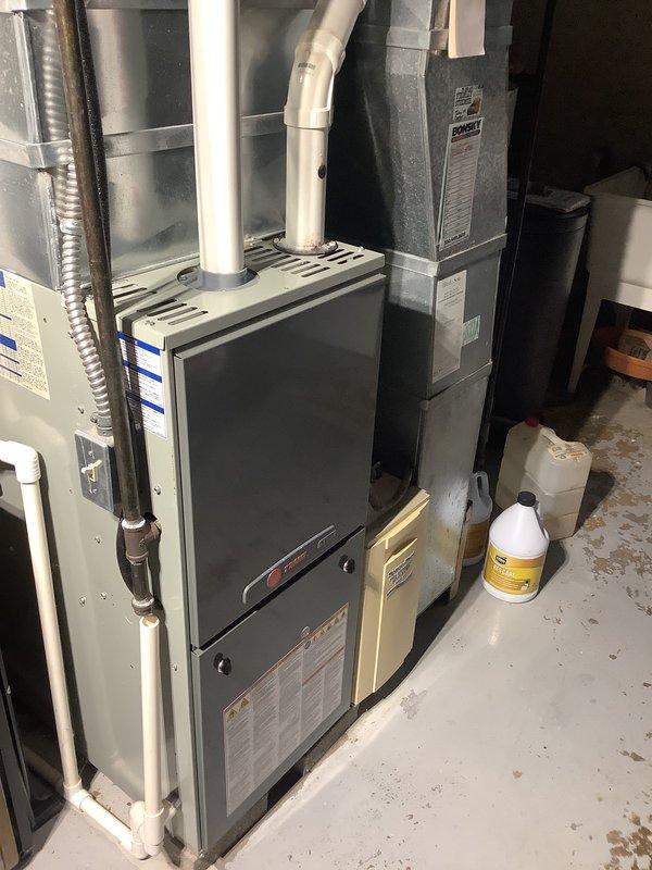Conducted comprehensive assessment of existing HVAC system in basement mechanical room to provide replacement estimate. Evaluated current furnace unit with PVC venting, adjacent air handler, and associated ductwork infrastructure. Documented equipment specifications, installation configuration, and attic space conditions including insulation and existing pipe routing to determine system replacement requirements and provide mid-range equipment options suitable for homeowner's timeline considerations.