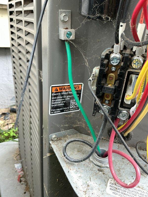 Completed MVP recurring cooling maintenance visit on residential HVAC system. Accessed electrical compartment and inspected contactor assembly, wiring connections, and grounding components. Observed cobwebs and debris accumulation indicating extended period since last internal cleaning. Verified electrical disconnect box mounted on exterior wall with proper conduit connections. All electrical connections found secure with no immediate safety concerns noted.