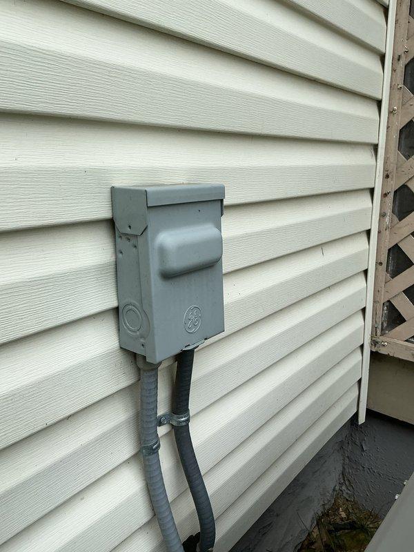 Completed MVP recurring cooling maintenance visit on residential HVAC system. Accessed electrical compartment and inspected contactor assembly, wiring connections, and grounding components. Observed cobwebs and debris accumulation indicating extended period since last internal cleaning. Verified electrical disconnect box mounted on exterior wall with proper conduit connections. All electrical connections found secure with no immediate safety concerns noted.