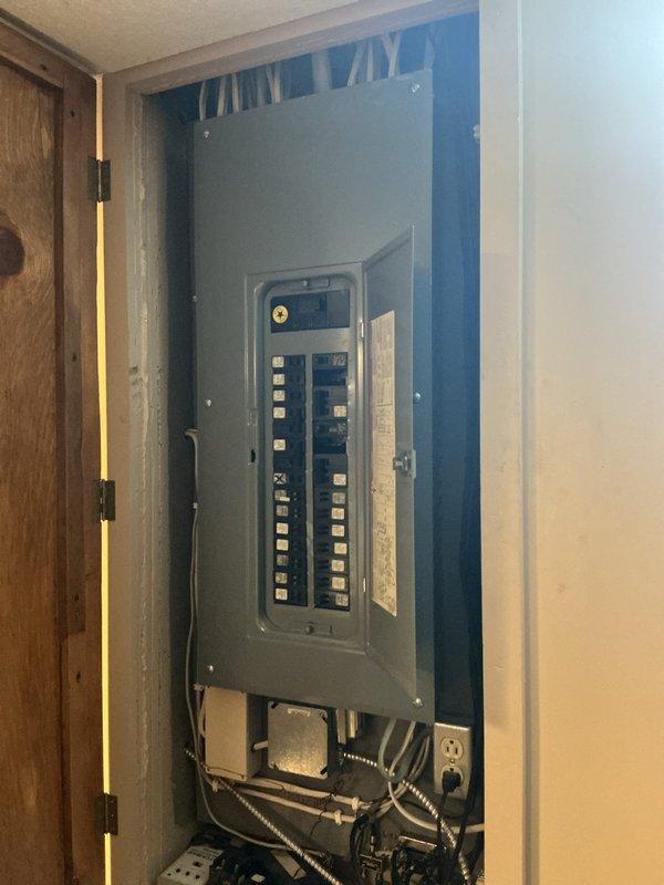 Installed exterior security camera fixture on residential siding with proper mounting and electrical connections. Relocated garage ceiling light to center position for improved illumination coverage, including circuit verification at main electrical panel.