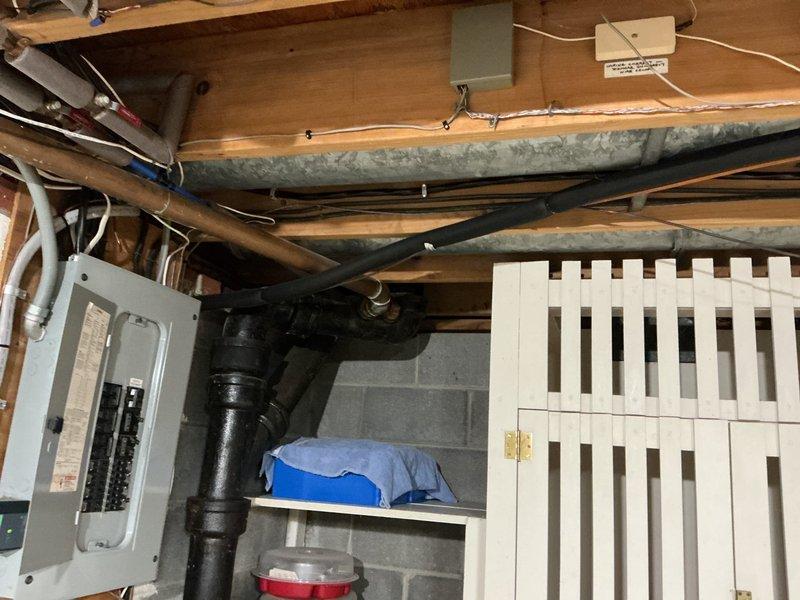 Installed a dedicated 50-amp, 240-volt circuit for Tesla electric vehicle charger. Removed existing breaker from electrical panel to accommodate new two-pole 50-amp breaker. Ran 6-3 Romex wire through basement to garage area and terminated at disconnect switch mounted on garage joist. Installed three-quarter inch PVC conduit from disconnect across garage ledge to charger mounting location. Pulled #6 THHN conductors through conduit and completed installation of Tesla wall charger at requested joist-mounted position, ensuring all connections met NEC requirements for EV charging equipment.