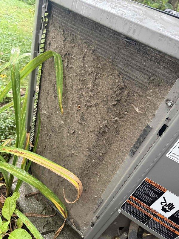 Completed preventative maintenance tune-up on residential outdoor AC condenser unit. Upon arrival, found heavily soiled condenser coils with thick accumulation of dirt, dust, and debris restricting airflow, along with significant exterior cabinet contamination. Cleaned condenser coils, removed debris buildup, and inspected all accessible components to restore unit to proper operating condition.