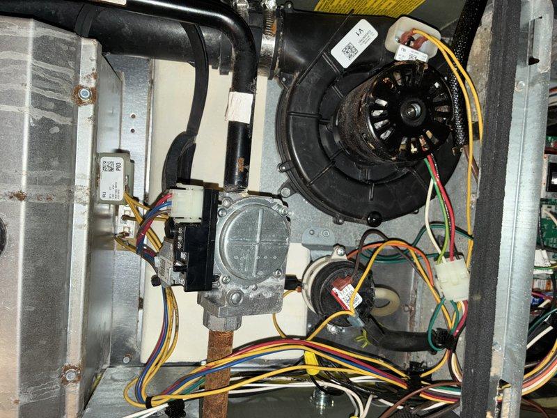 Completed comprehensive MVP air conditioning maintenance service on residential HVAC system. Performed thorough inspection of all major components including blower wheel assembly, which showed moderate dust accumulation on the squirrel cage fan fins and housing. Examined blower motor assembly with multi-speed wiring connections, gas valve assembly, and associated refrigerant lines. Verified proper operation of electronic control boards and electrical connections throughout the system. All components found to be in operational condition with normal wear patterns consistent with regular use.