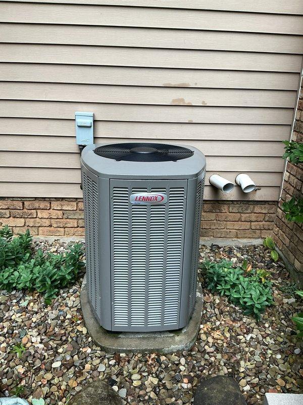 # HVAC Maintenance - Cooling

Completed comprehensive MVP cooling maintenance visit on 8-year-old Lennox air conditioning system. Performed standard seasonal inspection of outdoor condenser unit, including visual assessment of cabinet condition, louver vents, and fan assembly. Verified proper unit placement on concrete pad with adequate clearance from surrounding landscaping and building structure. Inspected electrical disconnect box, flexible conduit connections, and wiring routing along exterior wall. Confirmed PVC condensate lines are properly installed and secured. Unit operating within normal parameters with no immediate service concerns identified. All components show appropriate wear for equipment age. Documented system condition with photographic records for maintenance history.