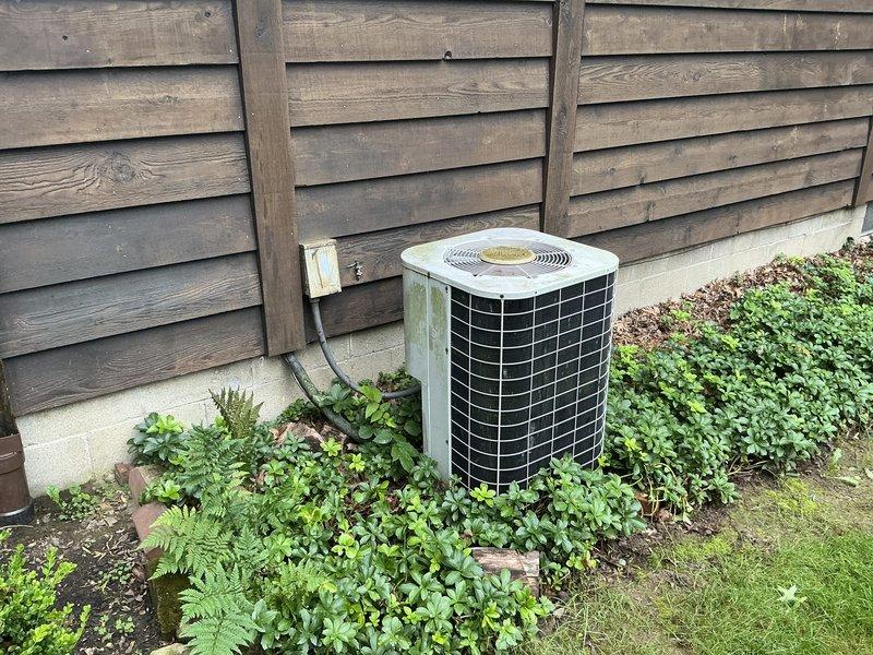 Conducted comprehensive assessment of existing residential HVAC system for replacement estimate. Evaluated indoor Amana furnace unit and associated ductwork in basement utility area, documenting equipment age, condition, and configuration. Inspected outdoor air conditioning condenser unit, electrical disconnect, and installation pad. Photographed both indoor and outdoor components to provide detailed documentation for replacement system specifications and scope of work.