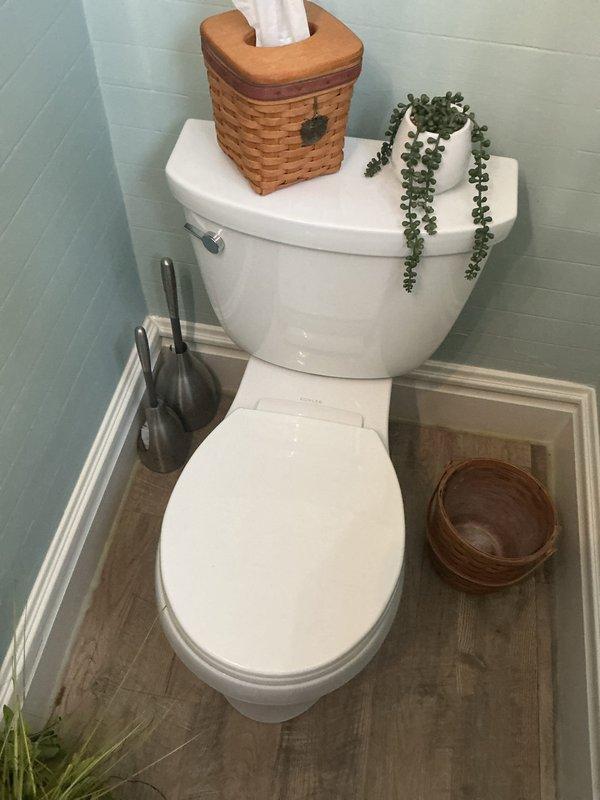 Responded to water leak in downpipe from first-floor toilet in 110-year-old home with newer bathroom addition. Accessed PVC drainage system from basement to locate and identify leak source in vertical drain stack. Inspected toilet connections, floor flange, and waste pipe joints in bathroom above, then traced piping through floor joists to pinpoint leak at compromised fitting connection in basement ceiling area. Tightened loose joint connection and verified proper seal on PVC drainage assembly. Tested system by flushing toilet multiple times and running water to confirm leak was resolved with no further dripping or moisture accumulation. Documented existing conditions of basement plumbing infrastructure and bathroom installation with photographs for reference.