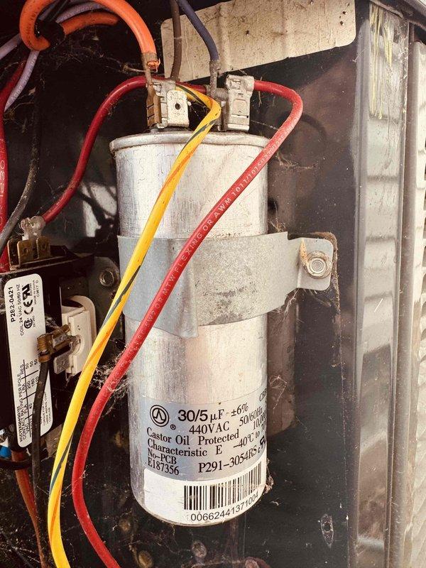Completed preventive maintenance cooling visit on 20-year-old HVAC system. Inspected blower wheel assembly and found moderate dust accumulation on blades but wheel remains operational with proper rotation. Verified dual-run capacitor (30/5 µF, 440VAC) is functioning within specifications with secure wire connections on all terminals. All electrical connections tight and secure with no signs of overheating or component failure. Unit operating normally at time of service.