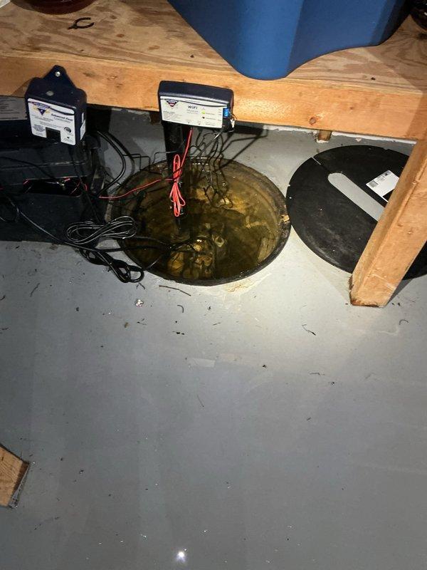 Responded to service call for sump pump battery backup system generating low battery notifications. Upon arrival, accessed property via remote entry system per customer instructions. Inspected the battery backup sump pump system located in basement utility area and confirmed the backup battery had reached end of service life and required replacement. Removed the depleted battery from the control unit, installed new replacement battery, and reconnected all electrical connections to the backup system. Tested system operation to verify proper functionality of both primary pump and battery backup components, ensuring reliable operation during customer's absence.
