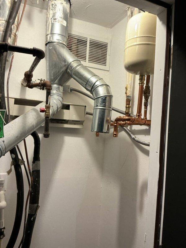 Performed hot water heater removal from mechanical room as requested by customer. Unit was disconnected from copper supply lines, drain valve, and gas line, then carefully extracted from confined utility space adjacent to HVAC equipment and ductwork. Second appointment scheduled for reinstallation of the water heater once customer's preparations are complete.
