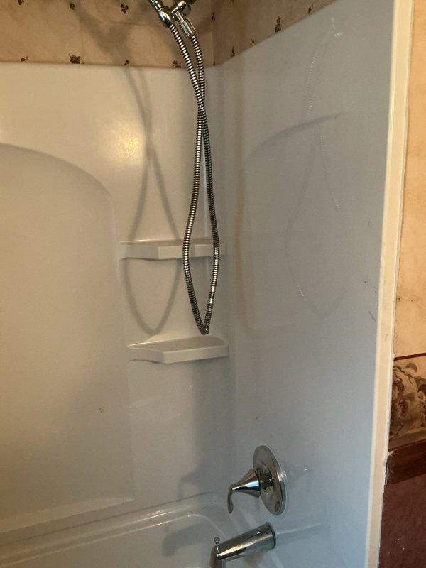 Completed shower valve replacement requiring drywall access panel installation to reach waste and overflow assembly. Removed existing defective shower valve, installed new valve assembly, and cut necessary drywall openings for proper access to plumbing components. Parts have been ordered for second appointment to complete final installation and finish work.