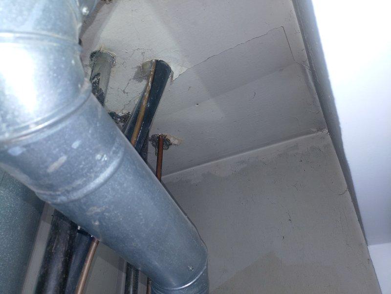 Responded to warranty call for water intrusion around roof vent penetration on recently installed HVAC system. Inspected attic space and identified inadequate flashing and sealant at vent termination point. Removed existing boot flashing, applied new weatherproof underlayment, and installed properly sized storm collar with high-grade silicone sealant to create watertight seal around vent pipe. Verified proper pitch and drainage of vent cap to prevent water pooling during rain events.