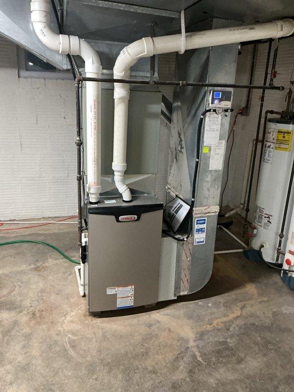 Elevated Lennox furnace unit onto platform base and upgraded return air drop to 14" x 25" dimensions to improve airflow capacity. Verified and adjusted blower motor speed settings to manufacturer specifications after concerns were raised regarding previous configuration. Secured all ductwork connections and PVC venting with proper strapping and support. System tested and confirmed operational with appropriate airflow parameters.