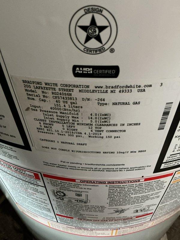 Installed new 40-gallon Bradford White short water heater (model RG240S6N) with 6-year manufacturer warranty, elevated on bricks above basement floor. Installation included new ball valve, expansion tank, and gas shut-off valve. Replaced old gate valve on main water line with new ball valve, rebuilding piping back to meter with water department shutting off supply at street. Snaked main drain line approximately 75 feet from cleanout at base of stack to road connection. Removed existing brass cap and installed new 2.5-inch T-cone plug at cleanout access point.
