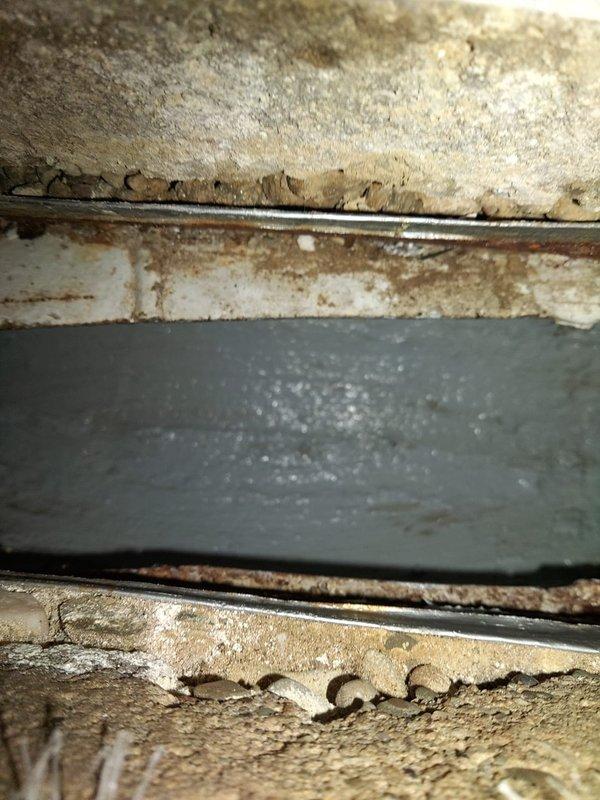 Completed ductwork reconnection and chimney patch repair in crawlspace area. Addressed compromised duct connections showing corrosion at metal band joints and reinstalled horizontal rectangular supply duct between floor joists. Secured all ductwork connections to ensure proper airflow and system efficiency while noting surrounding structural wood damage from insect activity for homeowner awareness.